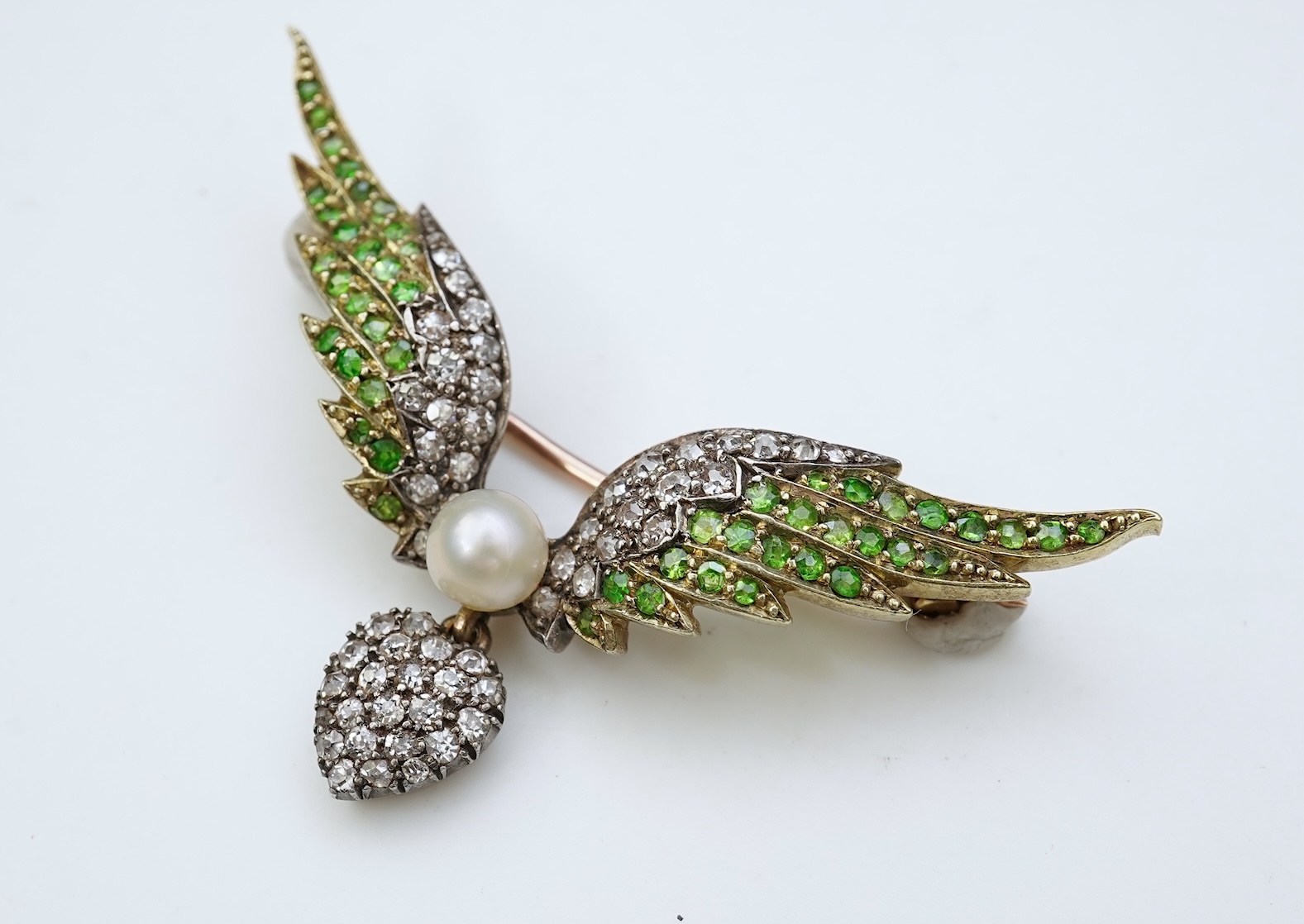 An attractive late Victorian demantoid garnet, pearl and diamond brooch, circa 1900